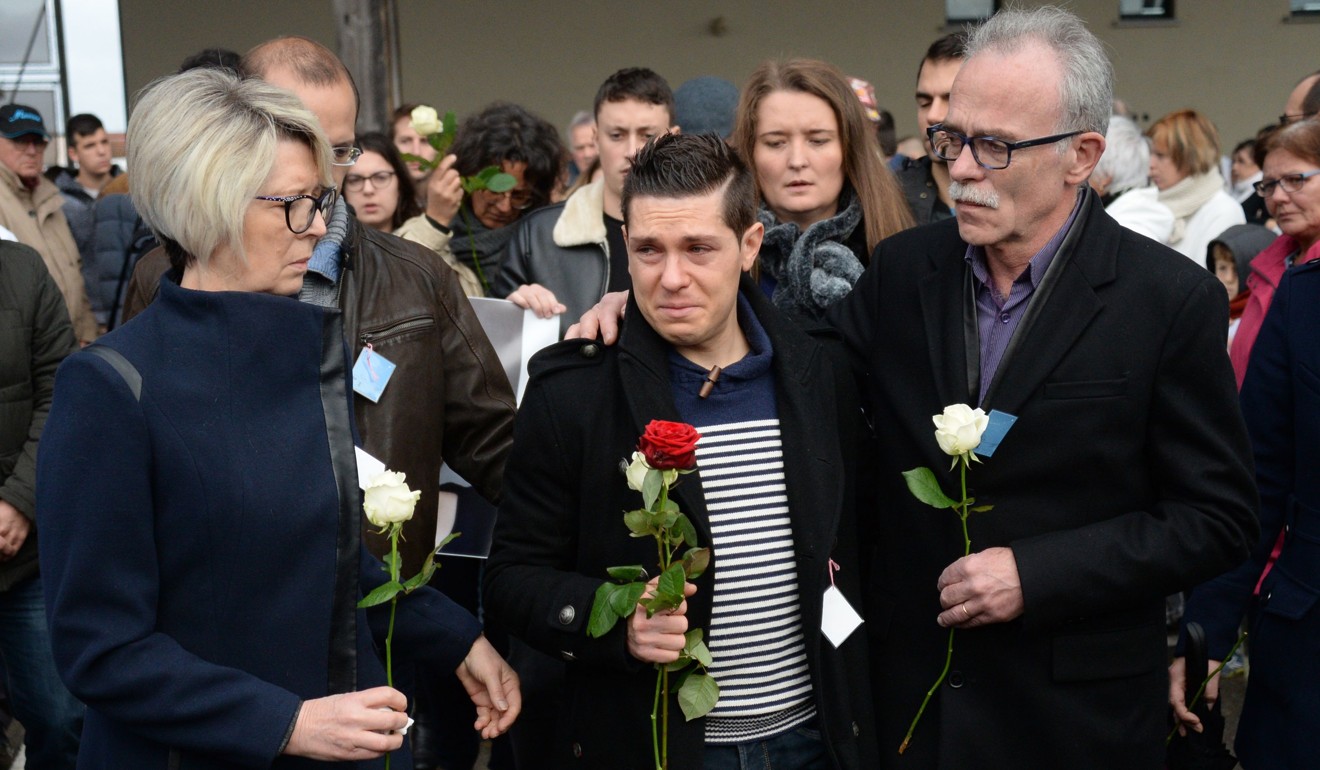 Isabelle Fouillot (left) and Jean-Pierre Fouillot (right), parents of murdered French woman Alexia Daval, are joined by her husband Jonathann Daval (centre) for a silent march in her memory in Gray, France in November 2017. Photo: AFP