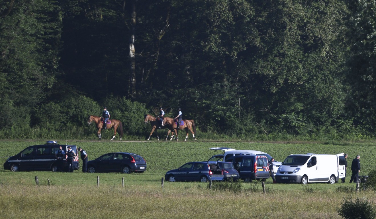 Police patrol the woods near Esmoulins, eastern France, during the re-enactment of the murder of Alexia Daval on Monday. Photo: AFP