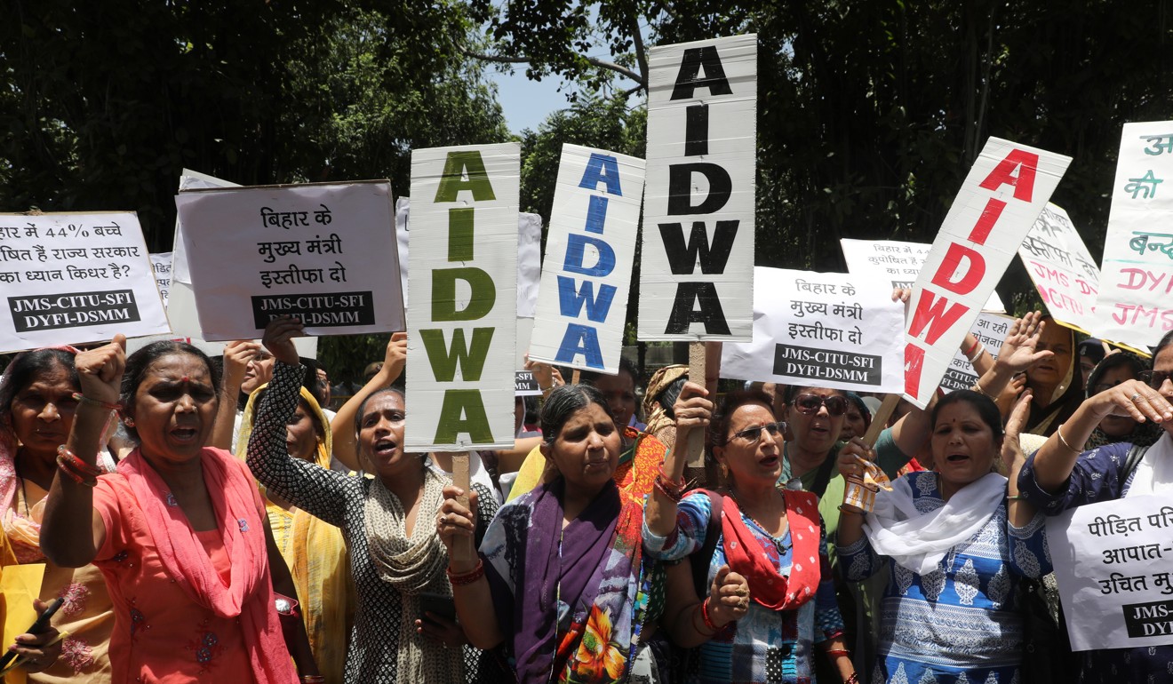 Indian activists with placards protest the deaths of children in the state of Bihar. Photo: EPA