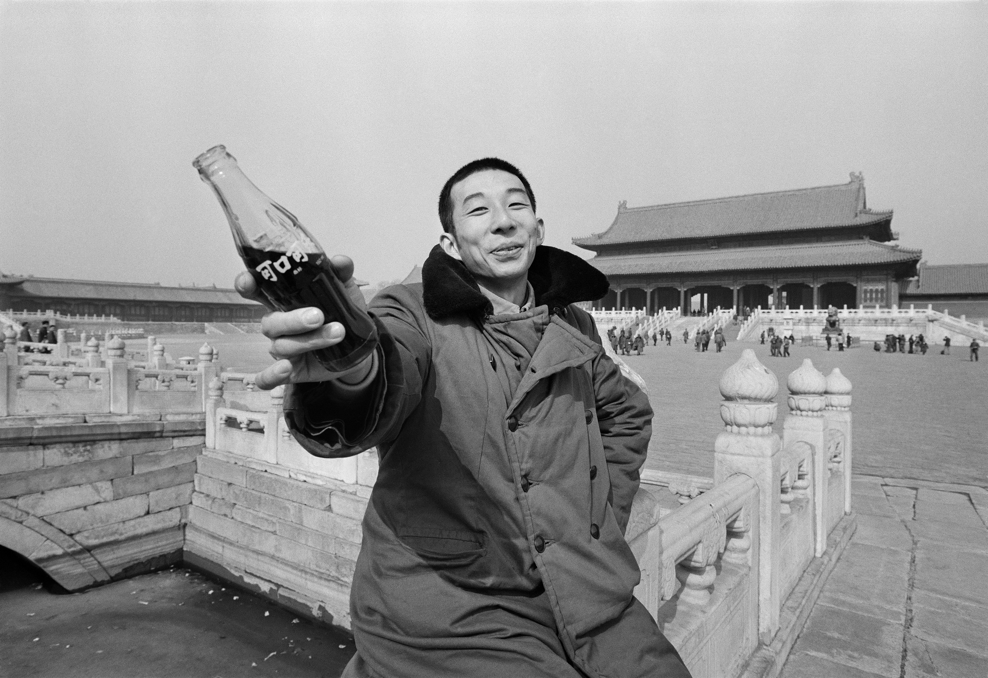 A young man with a bottle of Coca-Cola in the Forbidden City, Beijing in 1981. Photo: Liu Heung Shing