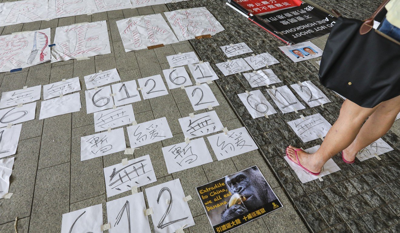 Protesters place signs and slogans on the ground outside the Legislative Council complex in Tamar on Thursday. Photo: Felix Wong