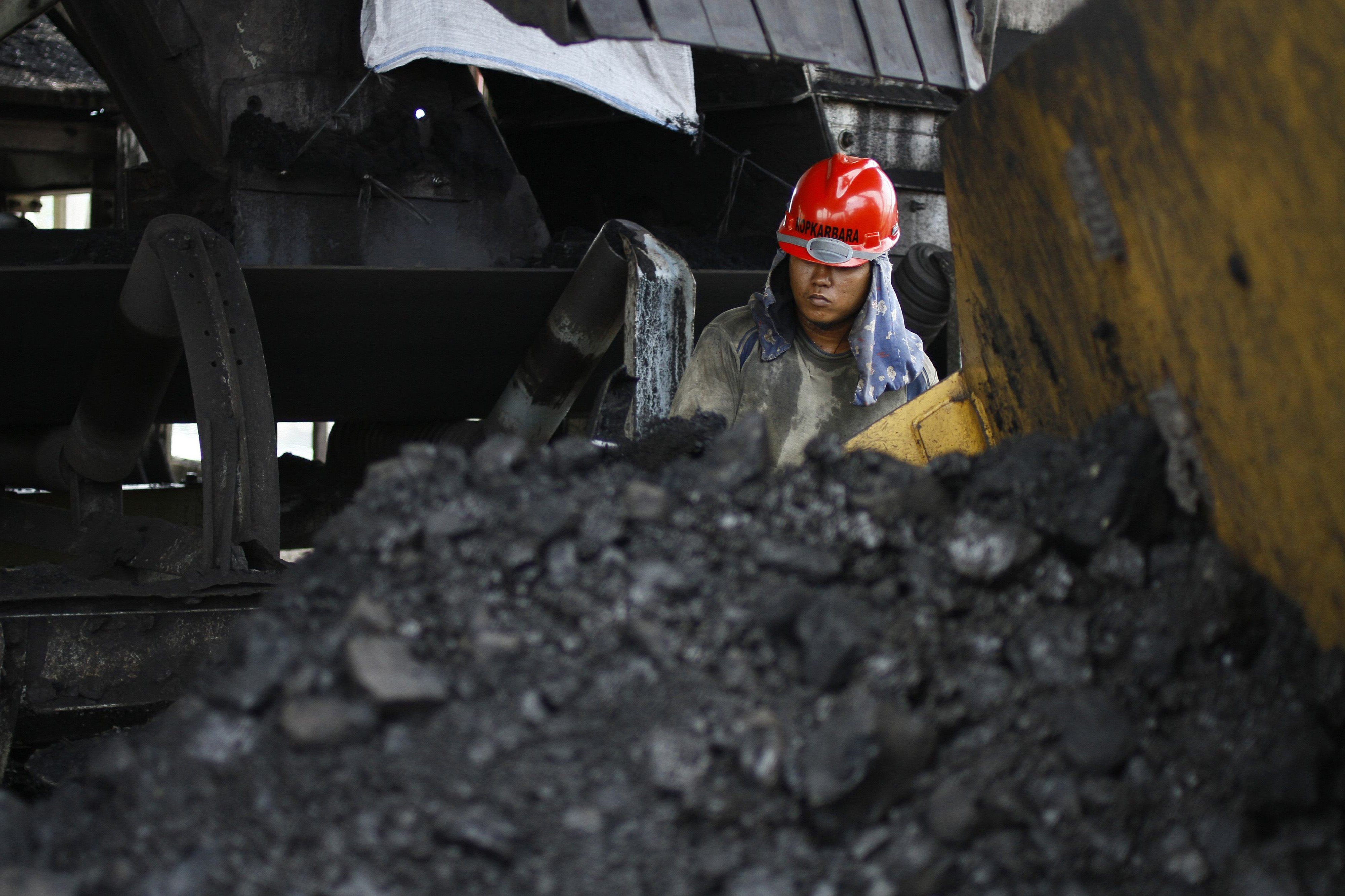 A miner at the Tarahan coal port in Lampung province, Indonesia. The US-China trade war could hit Indonesia’s raw goods exports. Photo: Reuters