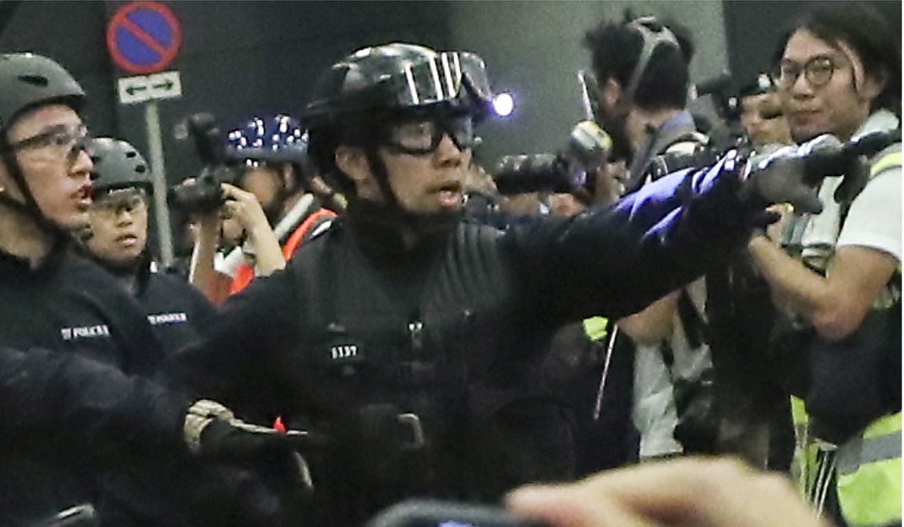 Special Tactical Squad officers with their police numbers displayed on their uniforms in the early hours of June 10. Photo: Sam Tsang