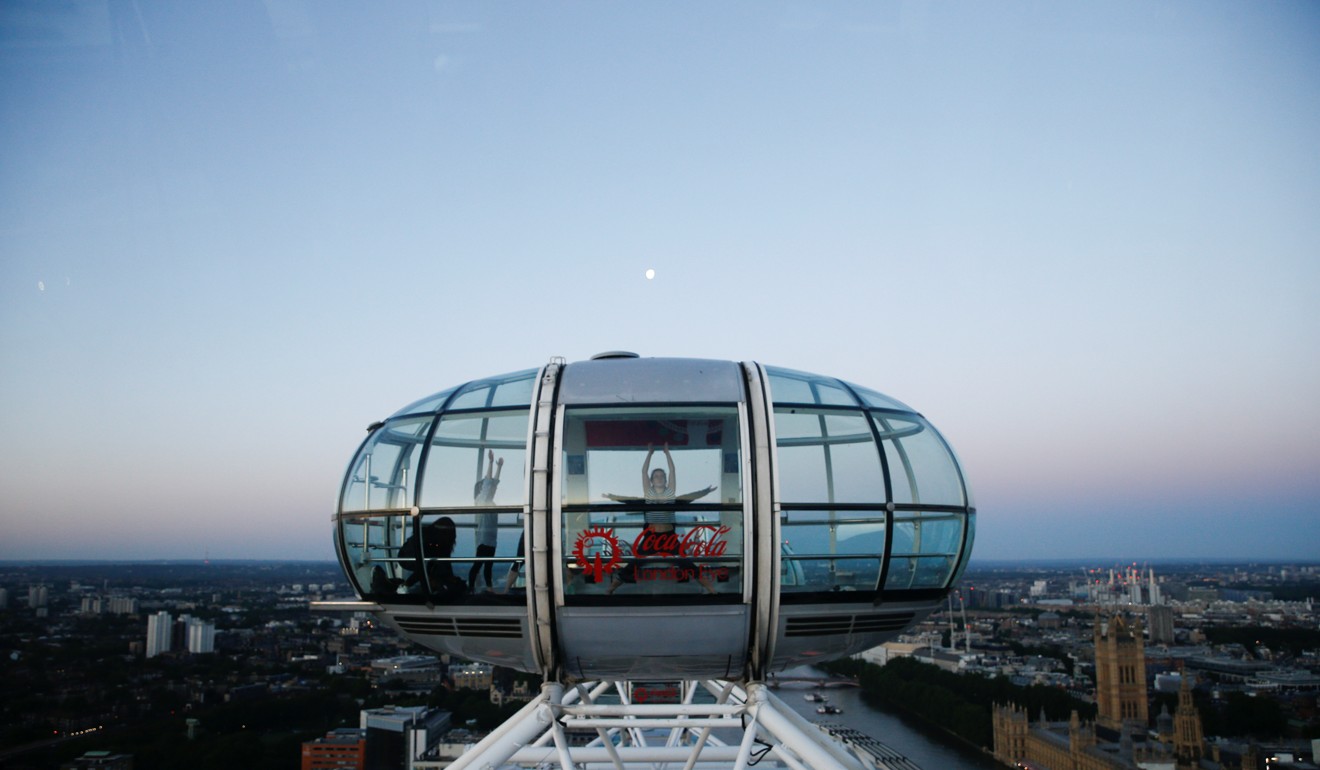 People perform yoga atop the London Eye. Photo: Reuters