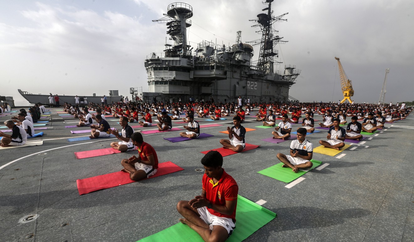 Indian Navy personnel take part in a yoga session on the deck of the decommissioned aircraft carrier INS Viraat in Mumbai. Photo: EPA-EFE