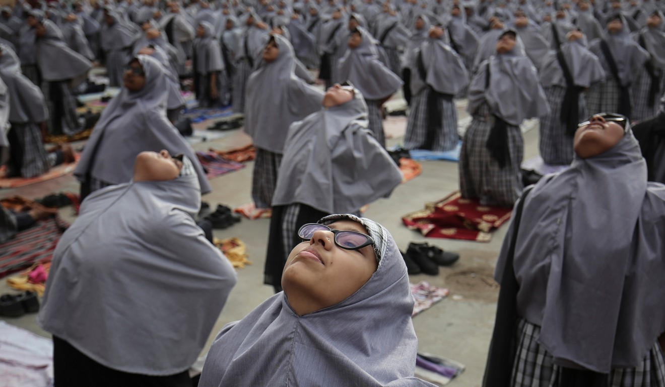 Muslim students perform yoga at a school in Ahmedabad, India. Photo: Reuters