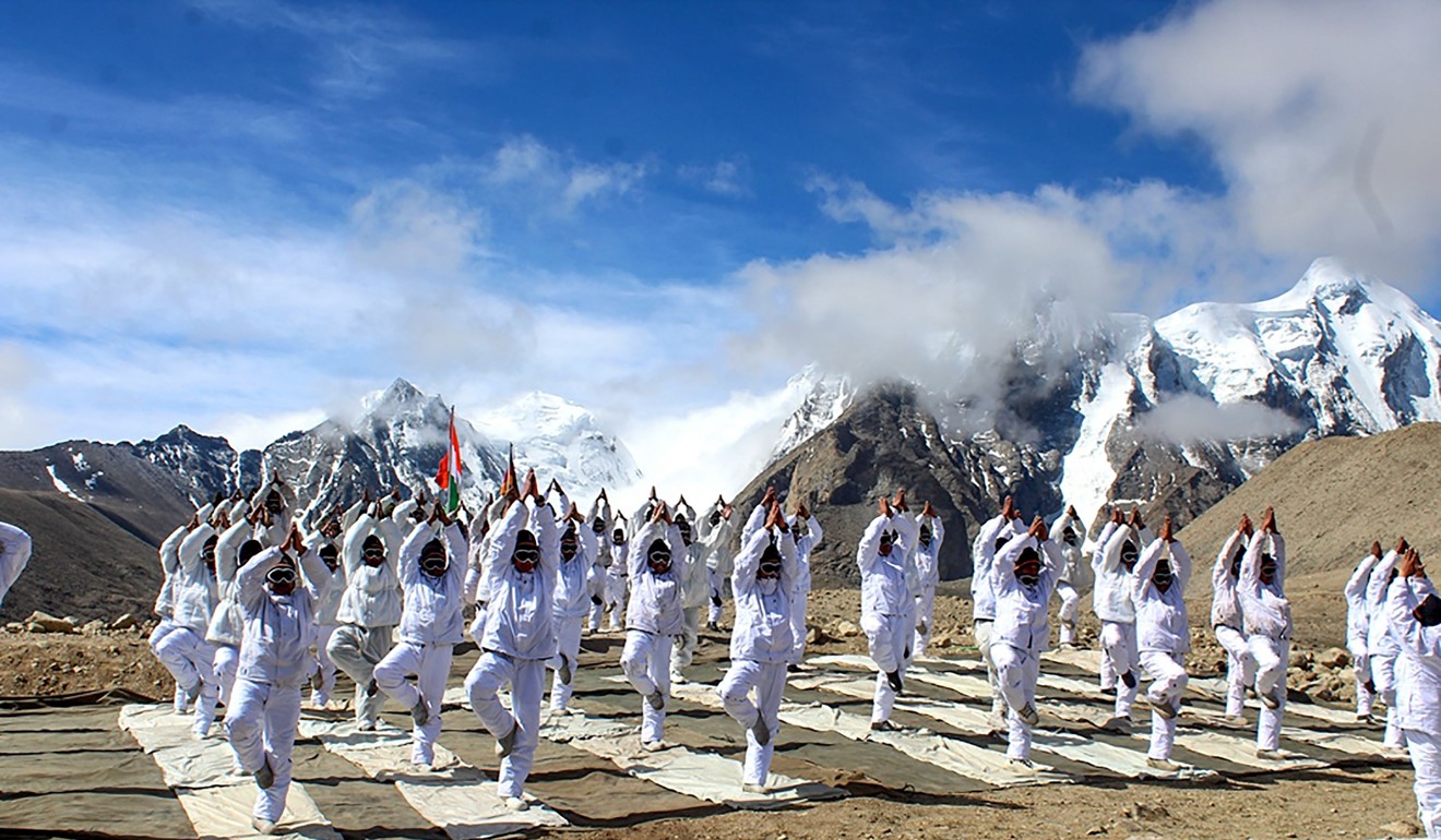 Chinese and Indian troops attend a joint yoga session at Nathu La in Sikkim. Photo: AFP