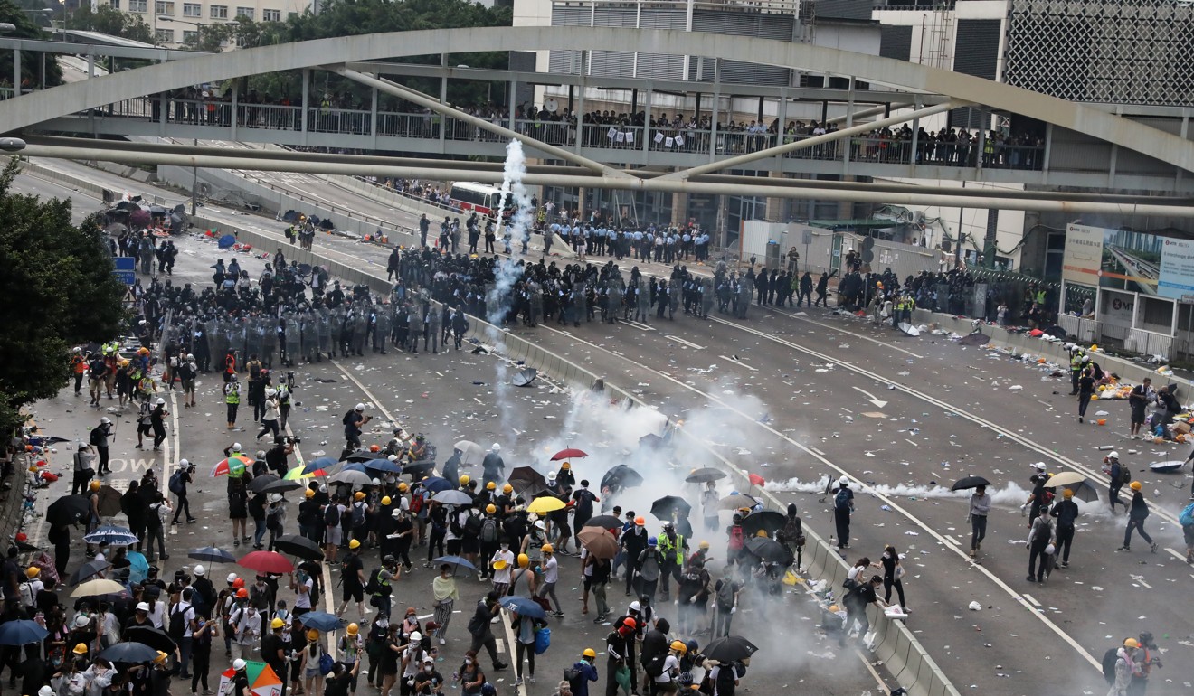 Anti-riot police officers fire tear gas at a group of anti-extradition bill protesters on Harcourt Road in Admiralty. Photo: K.Y. Cheng