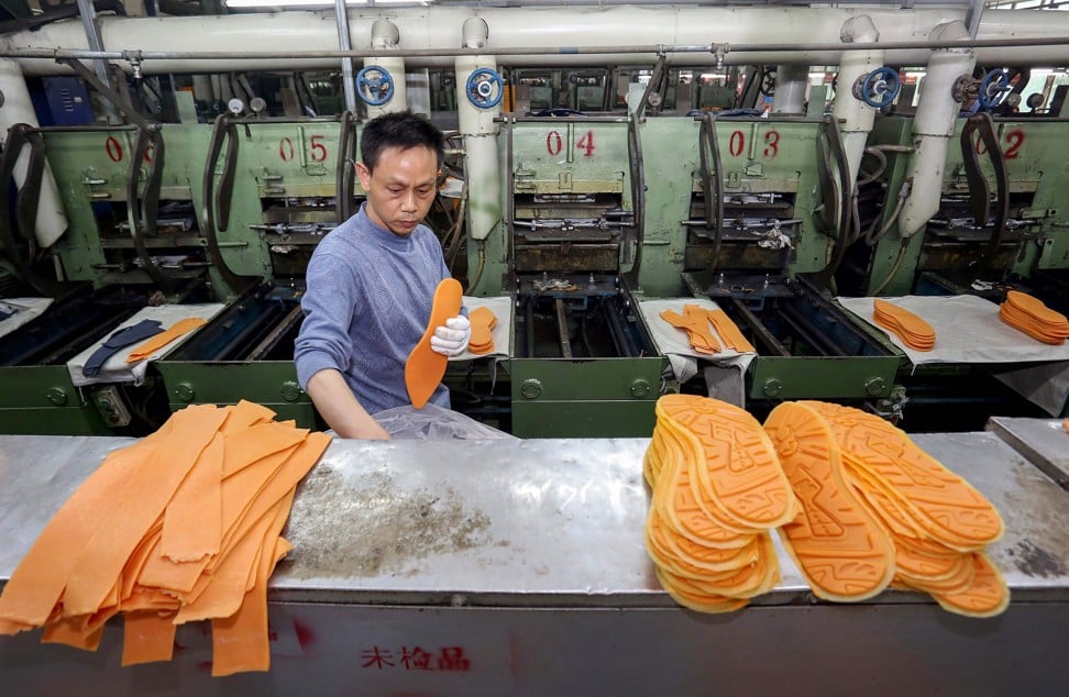 A worker producing rubber soles for leisure shoes in Jinjiang on March 9, 2017. Photo: AFP