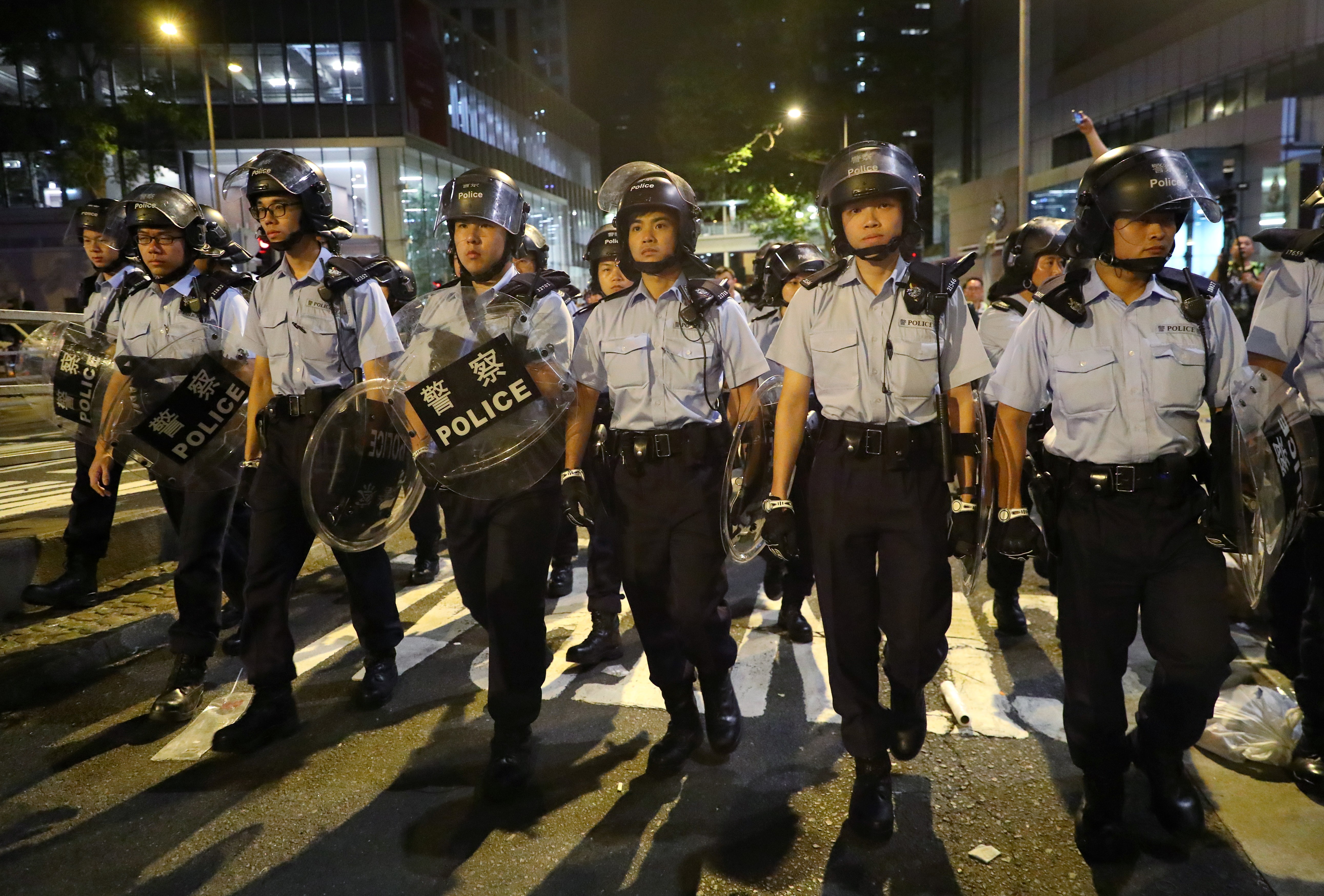 Police officers in anti-riot gear patrolling their headquarters in Wan Chai. Photo: Edmond So