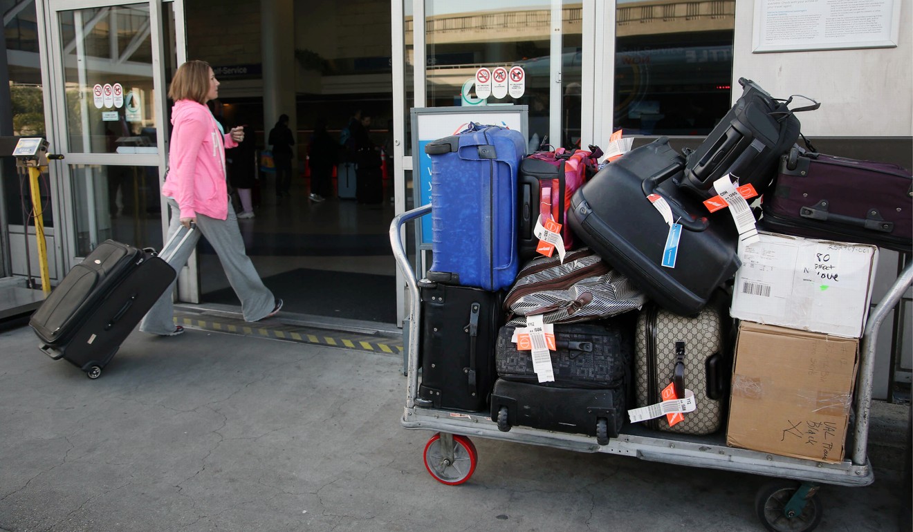 A passenger enters Los Angeles International Airport, where baggage handlers were accused of theft in 2014. Photo: AP