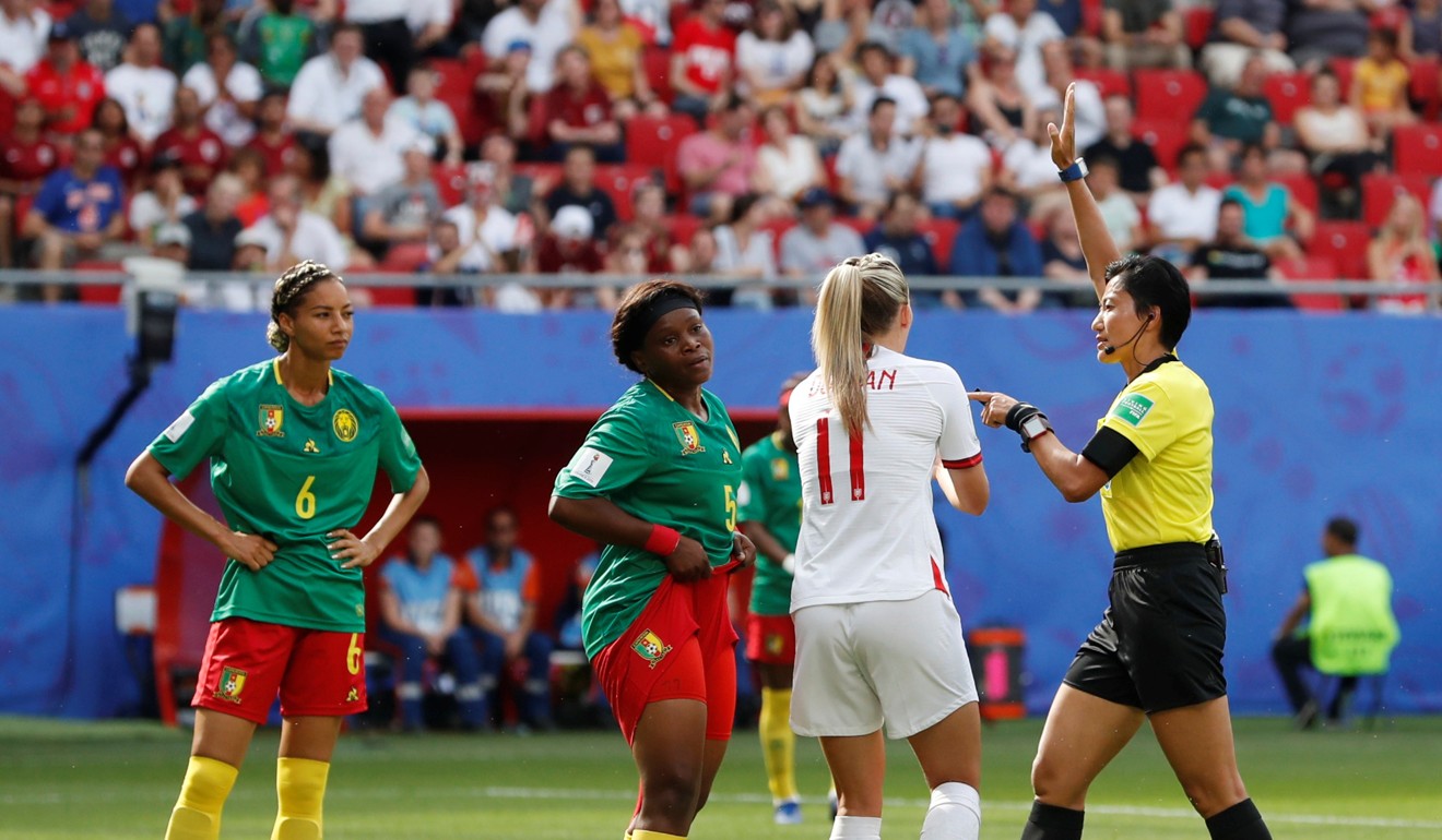 England's Toni Duggan appeals to referee Qin Liang after being spat on by Cameroon's Augustine Ejangue. Photo: Reuters