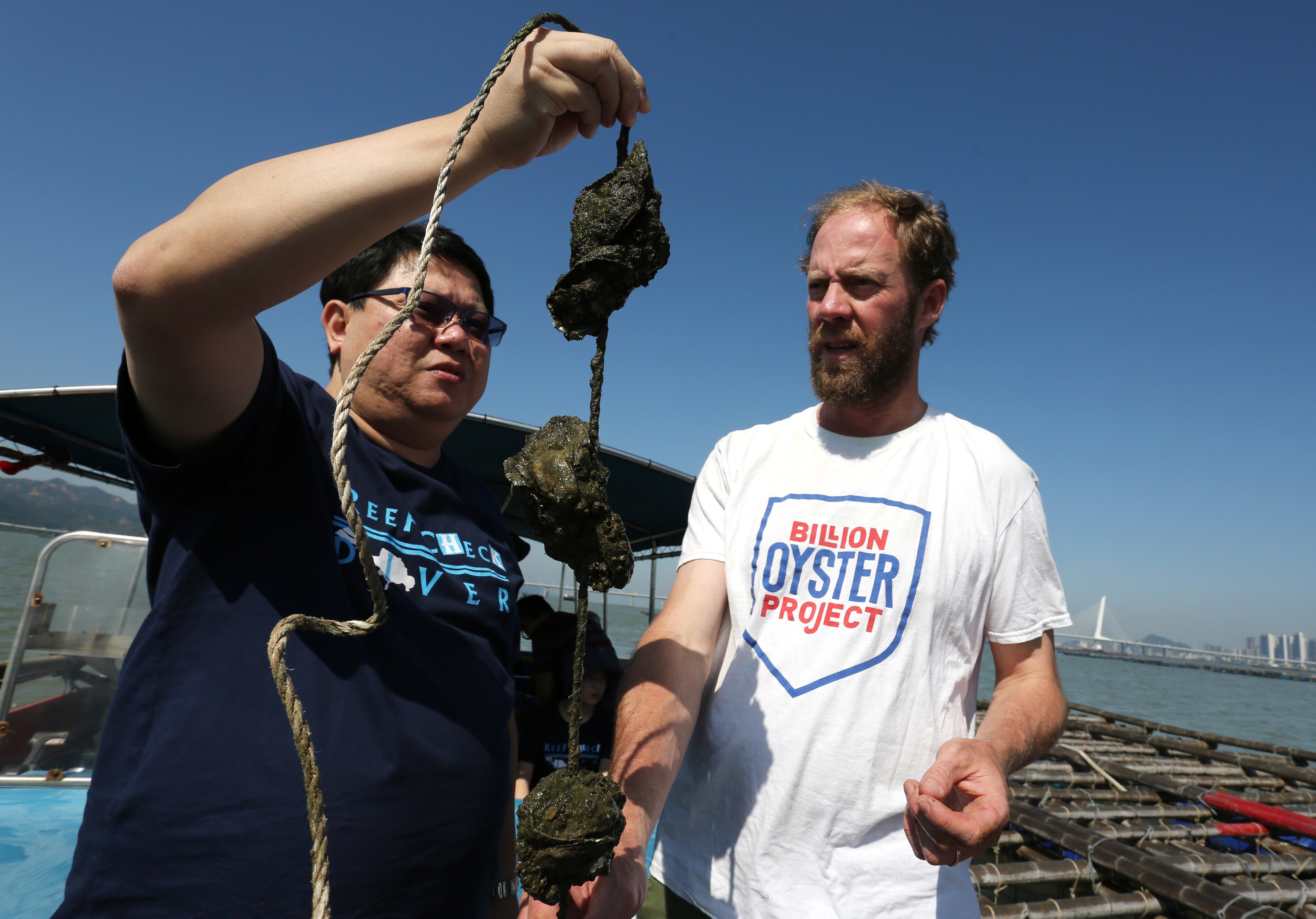 Professor Kenneth Leung of the University of Hong Kong (left) and New York Billion Oyster Project founder Murray Fisher visit an oyster farm in Lau Fau Shan. Photo: Jonathan Wong