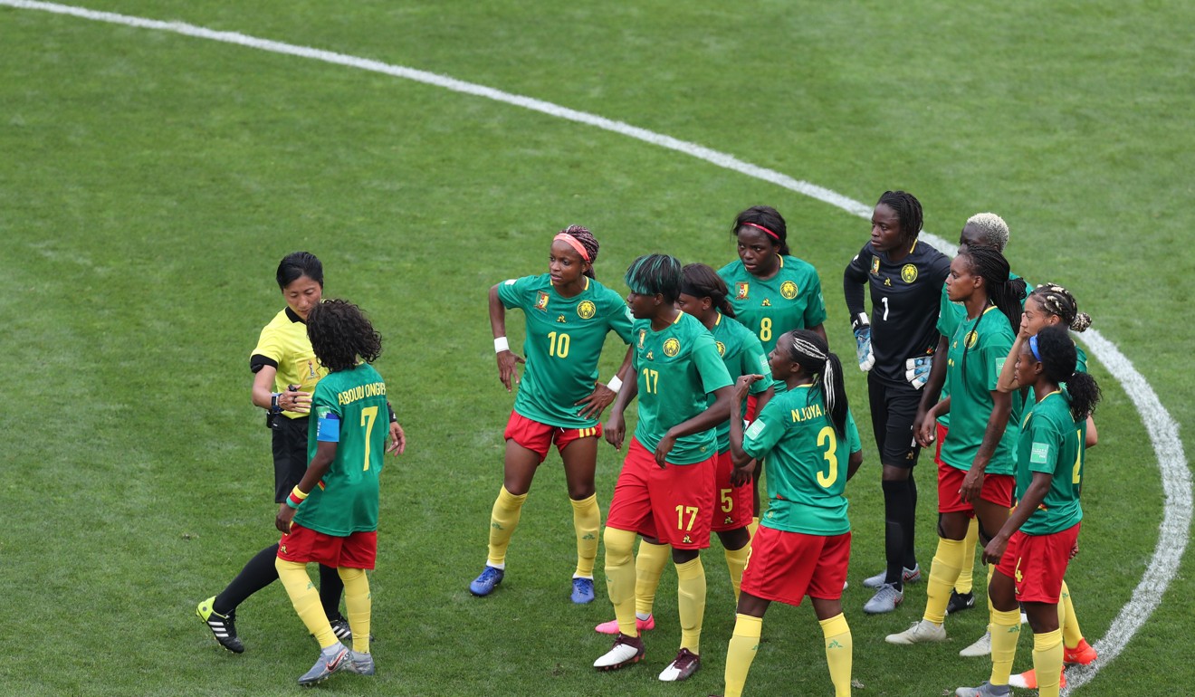 Cameroon players argue with the referee. Photo: Xinhua