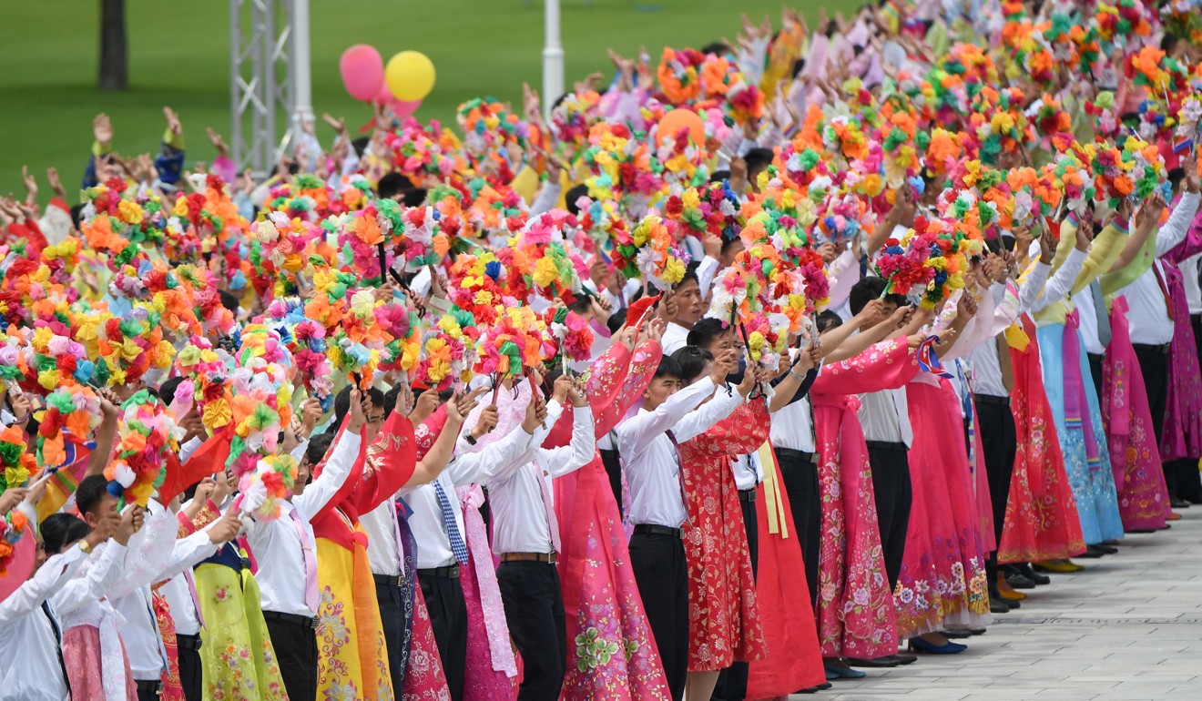 North Koreans in traditional dress turned out to greet Xi. Photo: Xinhua