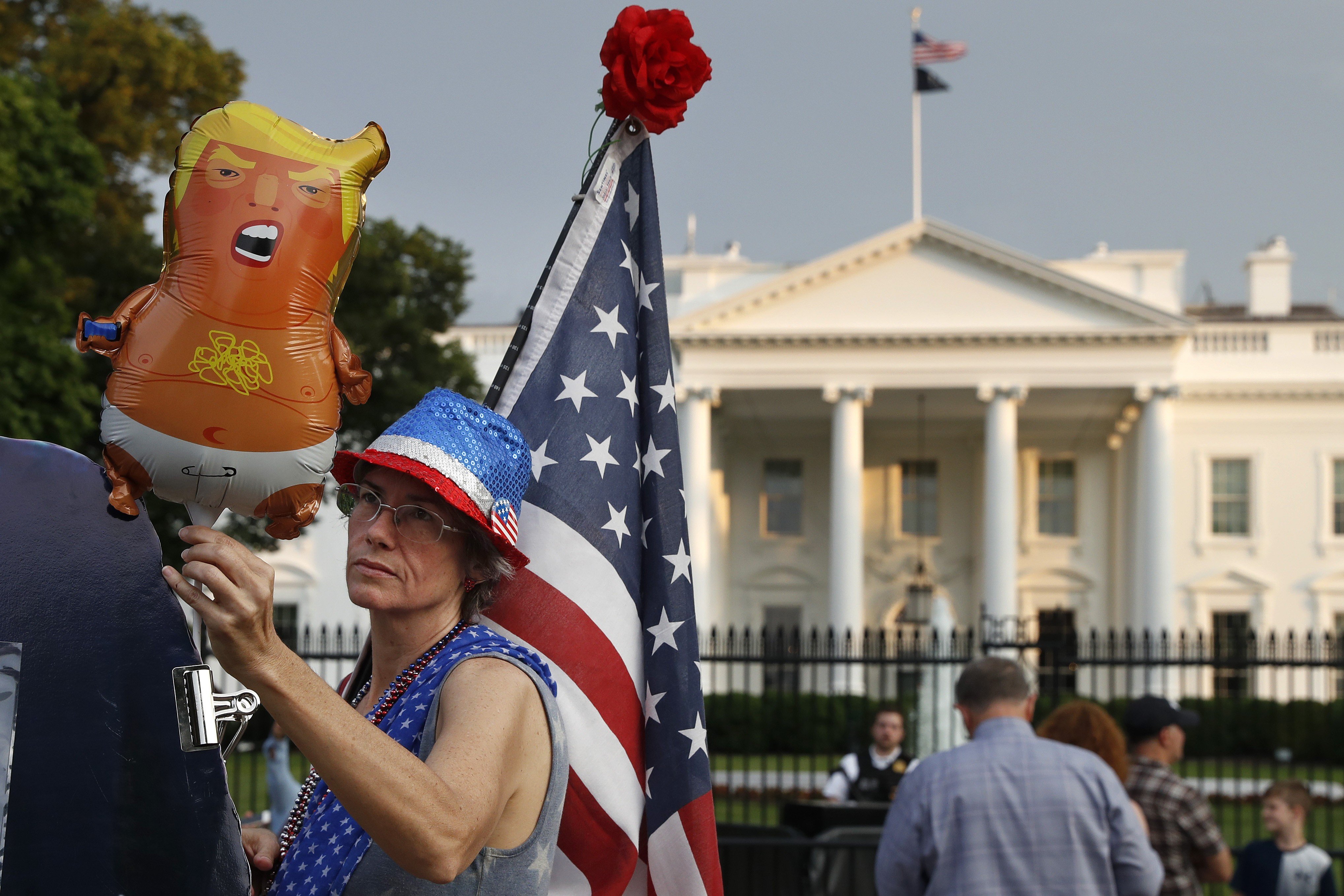 A woman who describes herself as “a resister” adjusts a “Trump baby” balloon in front of the White House at the start of a protest against the US president along Pennsylvania Avenue on May 18. Photo: AP