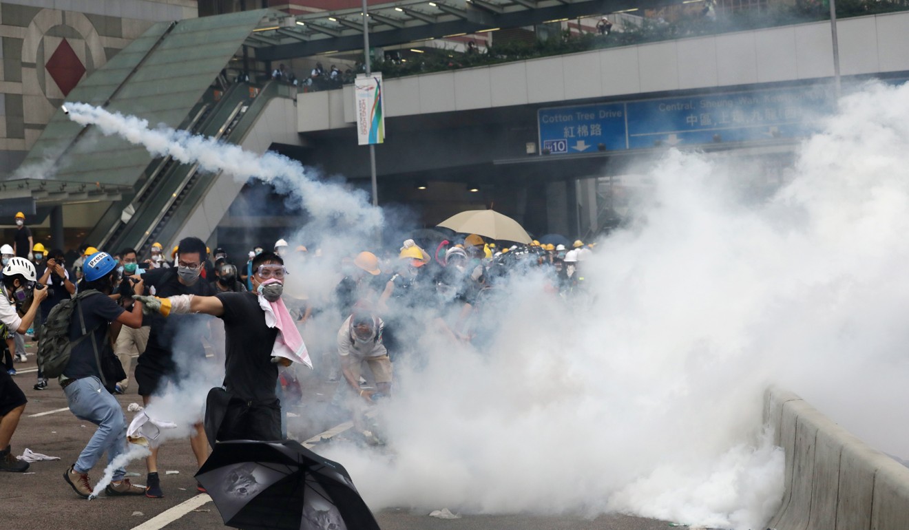 Protesters flee tear gas at Harcourt Road in Admiralty during clashes on June 12. Photo: Sam Tsang