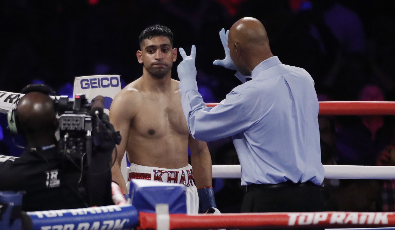 Amir Khan after being knocked down against Terence Crawford. Photo: Reuters