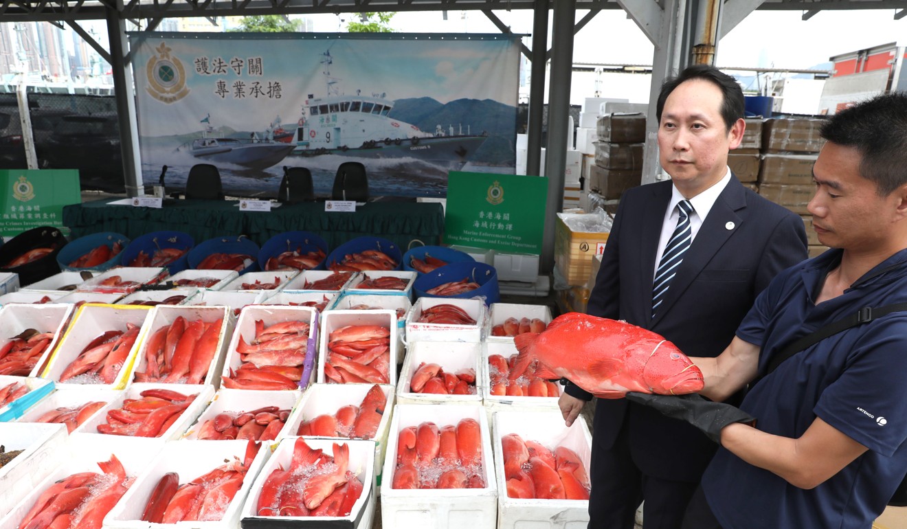 Wan Hing-chuen, a senior customs officer, with the five-tonne haul of coral grouper destined for dinner tables in mainland China, without tax being paid on them. Photo: Nora Tam