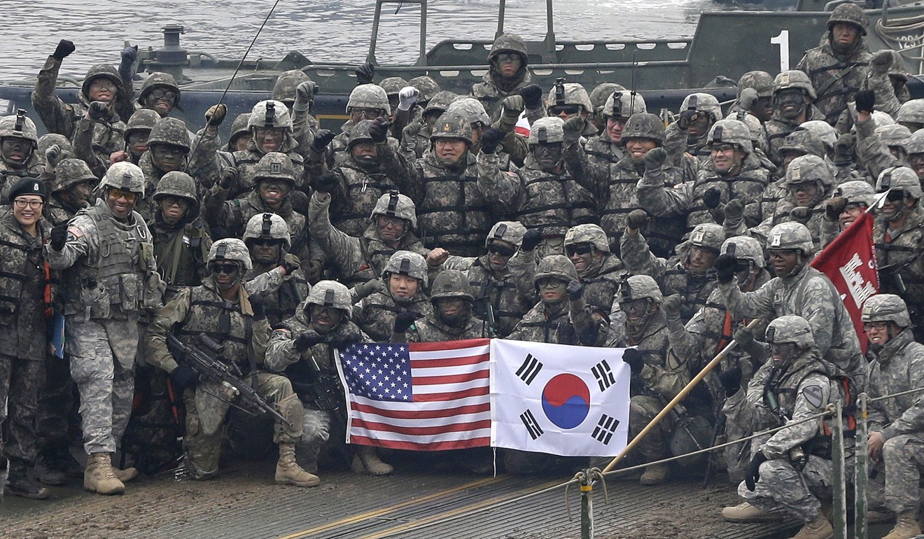 US and South Korean soldiers pose on a floating bridge on the Hantan river during a joint military exercise simulating an attack from North Korea. South Korea hosts 28,500 US troops on its soil. Photo: AP