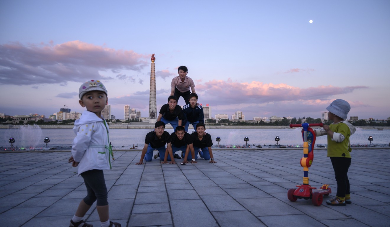 Children on banks of the Taedong river in Pyongyang. Alek Sigley posted about his colourful life in North Korea. Photo: AFP