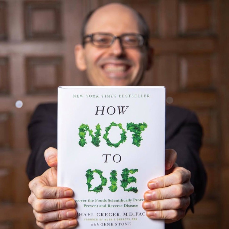 Dr Michael Greger with his book How Not to Die. Photo: Facebook