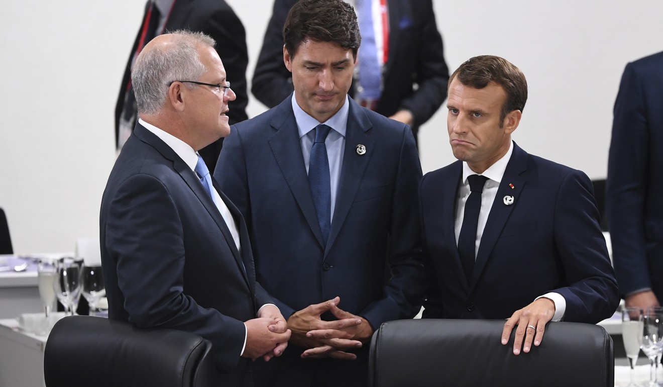Australian Prime Minister Scott Morrison (left) talks with Canadian Prime Minister Justin Trudeau and French President Emmanuel Macron during a digital economy session. Photo: DPA
