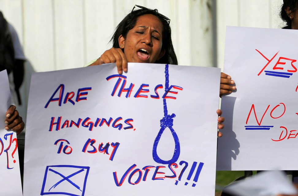 A woman at a protest condemning the death sentences for four people convicted of drug-related offences. Photo: Reuters