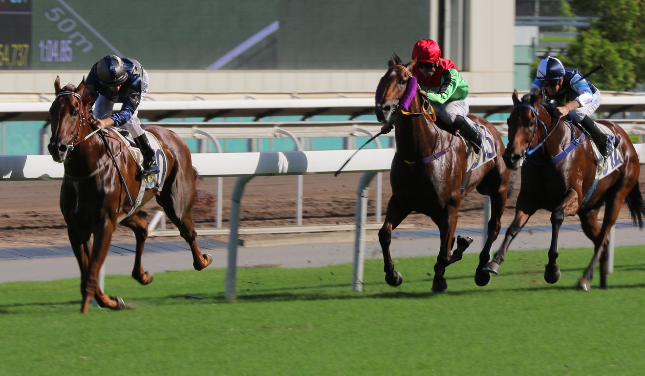 Jockey Zac Purton checks over his shoulder to see his rivals in the straight.