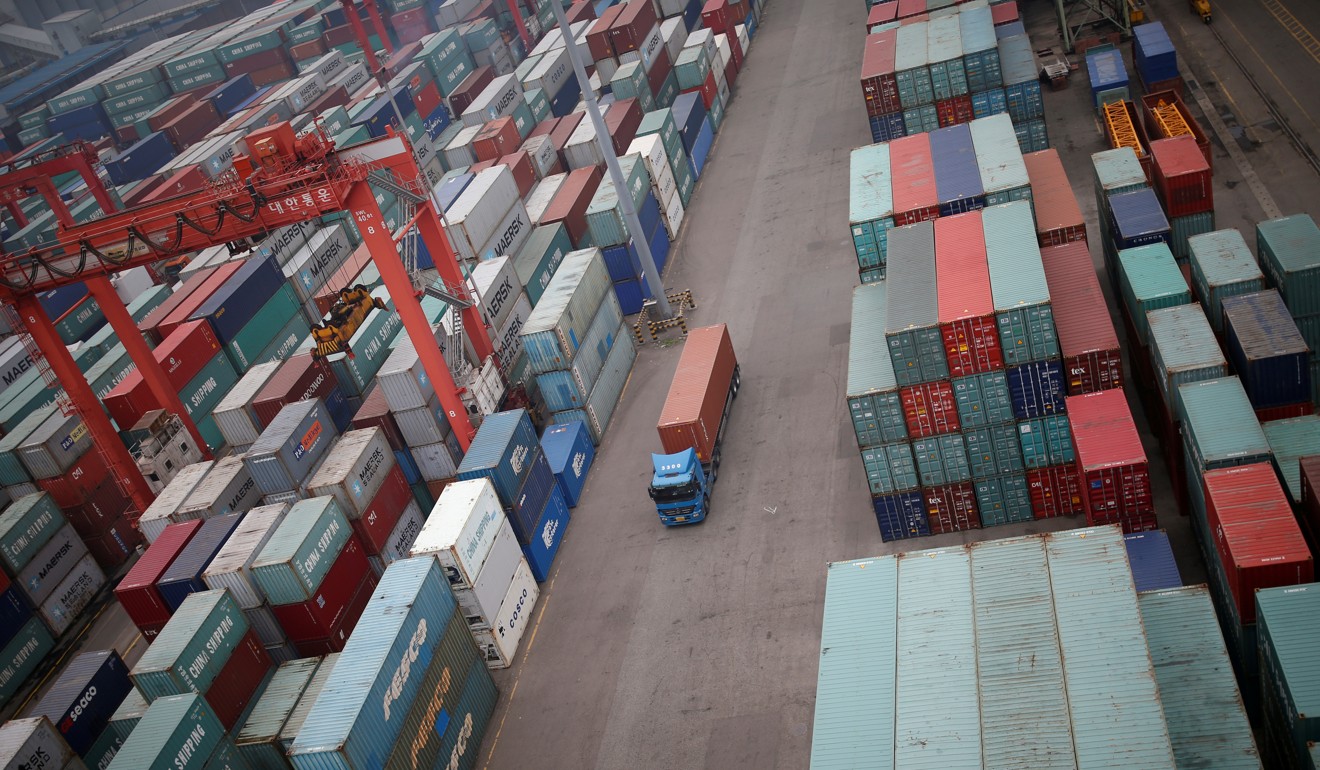A truck drives between shipping containers at a container terminal at Incheon port in Incheon, South Korea. Photo: Reuters