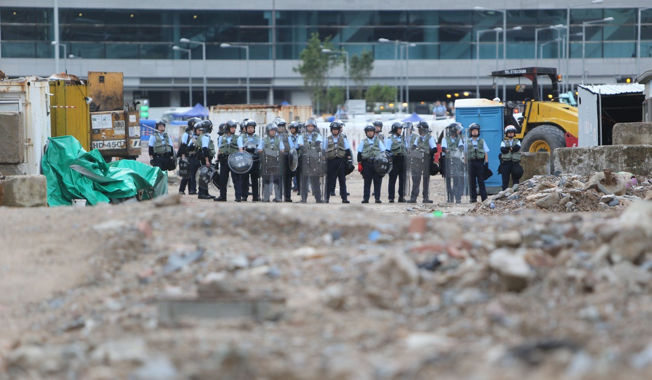 Hong Kong riot police stand ready at the waterfront. Photo: Winson Wong