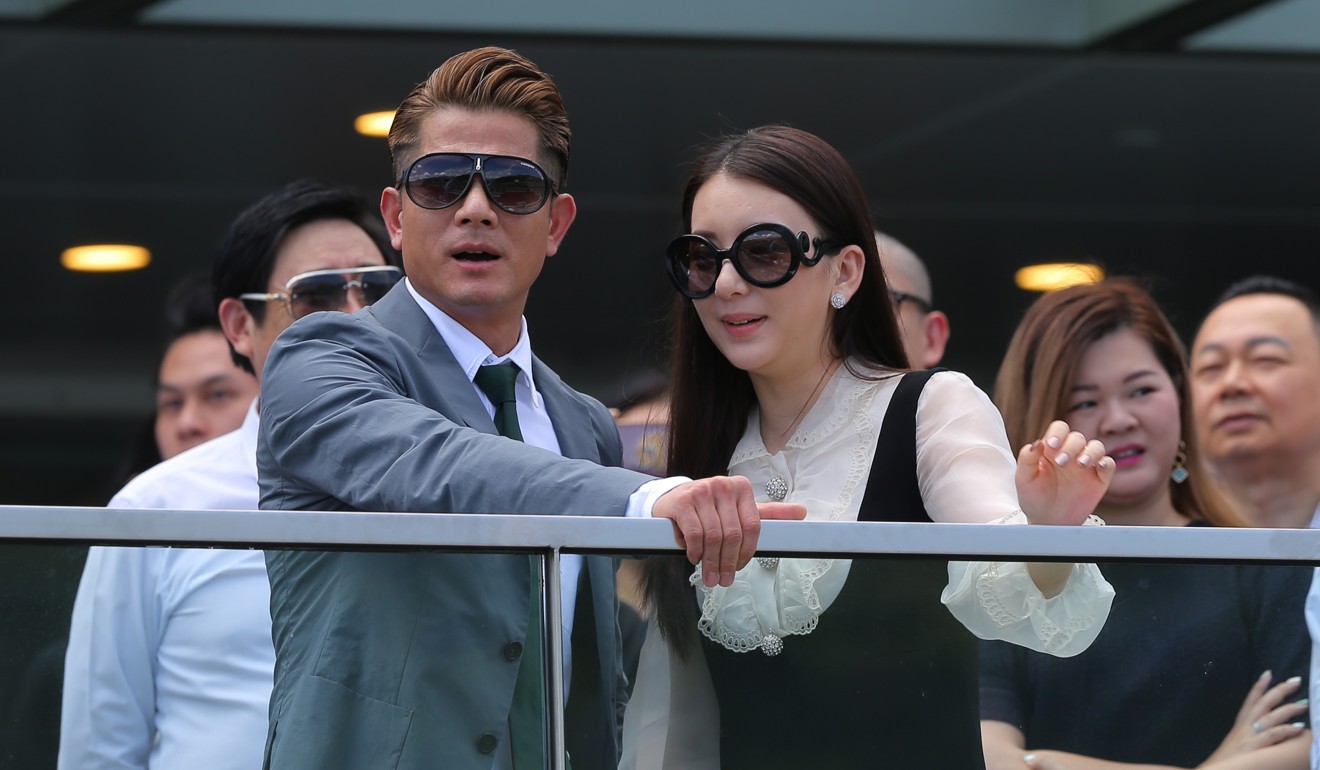 Canto-pop star Aaron Kwok watches on as his horse Dancing Fighter goes down.