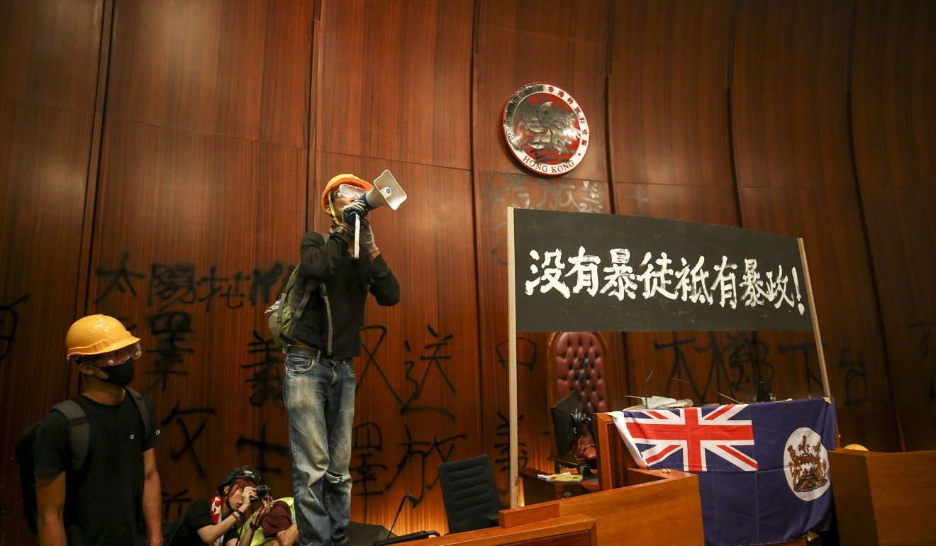 Protesters storm the Legislative Council Chamber on Monday, the 22nd anniversary of Hong Kong's handover from Britain to China. Photo: Winson Wong