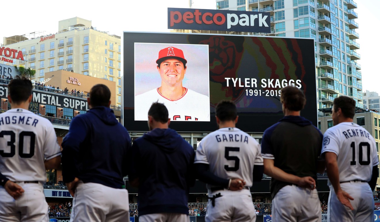 Players for the San Diego Padres and San Francisco Giants stand during a moment of silence for pitcher Tyler Skaggs. Photo: AFP