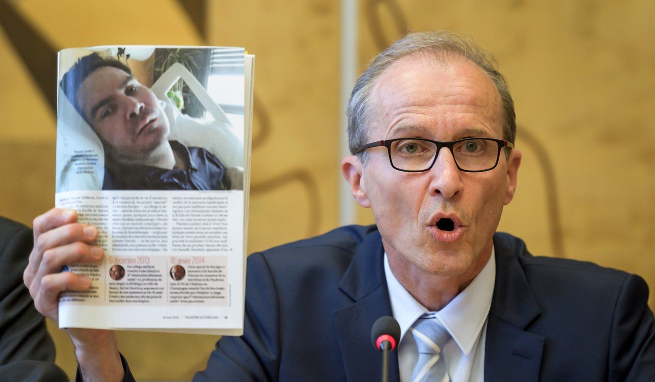 Neurologist Xavier Ducrocq, an adviser to Viviane Lambert, shows a picture of Vincent Lambert during an event on the sidelines of the UN Human Rights Council in Geneva on Monday. Photo: AFP