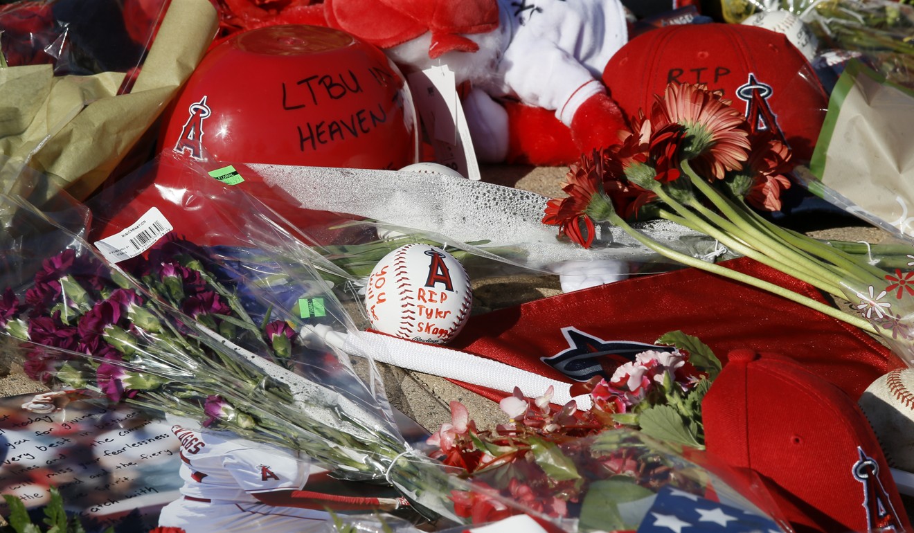 Los Angeles Angel fans place flowers, hats and mementos for pitcher Tyler Skaggs. Photo: AP