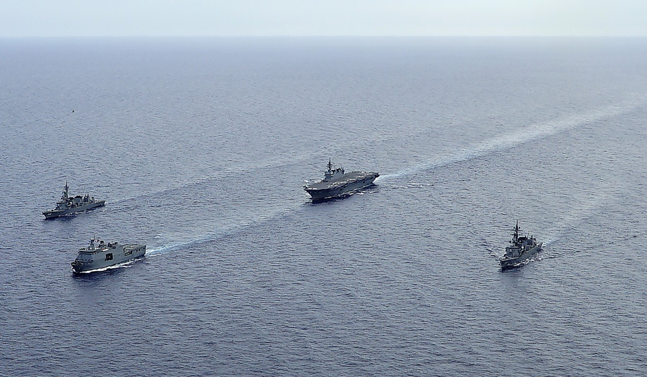 Izumo, centre, with destroyers Akebono, Murasame, and a Philippine amphibious transport dock. Photo: AP