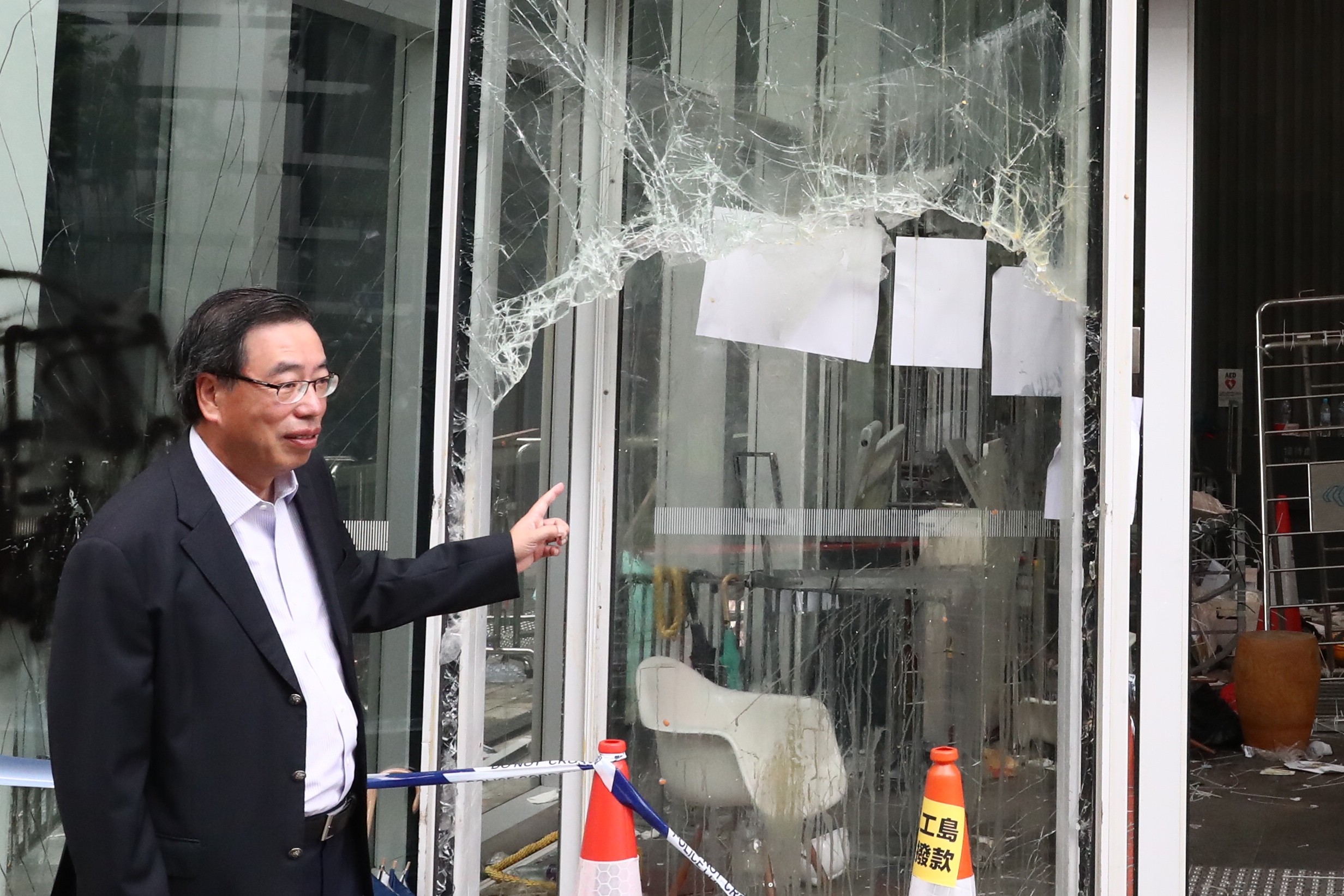Andrew Leung, president of the Legislative Council, inspects the damage to the Legco building on Tuesday. Photo: Nora Tam