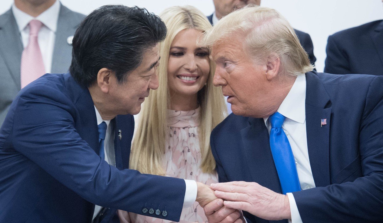 Ivanka Trump watches as her father Donald shakes hands with Japanese Prime Minister Shinzo Abe at the G20 summit. Photo: PA wire