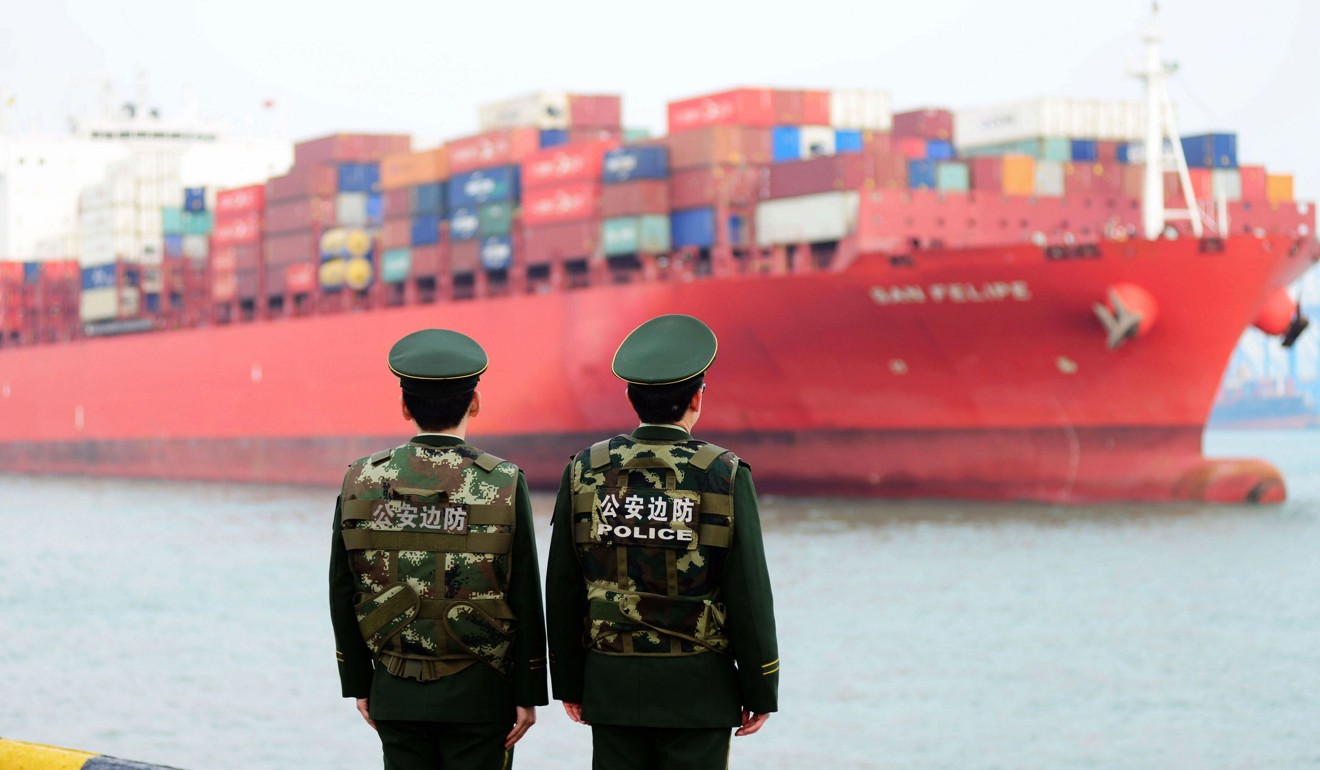 Chinese police officers watch a cargo ship come into port in Qingdao. China has made it clear it would rather higher tariffs than a trade deal that undermines its dignity. Photo: AFP