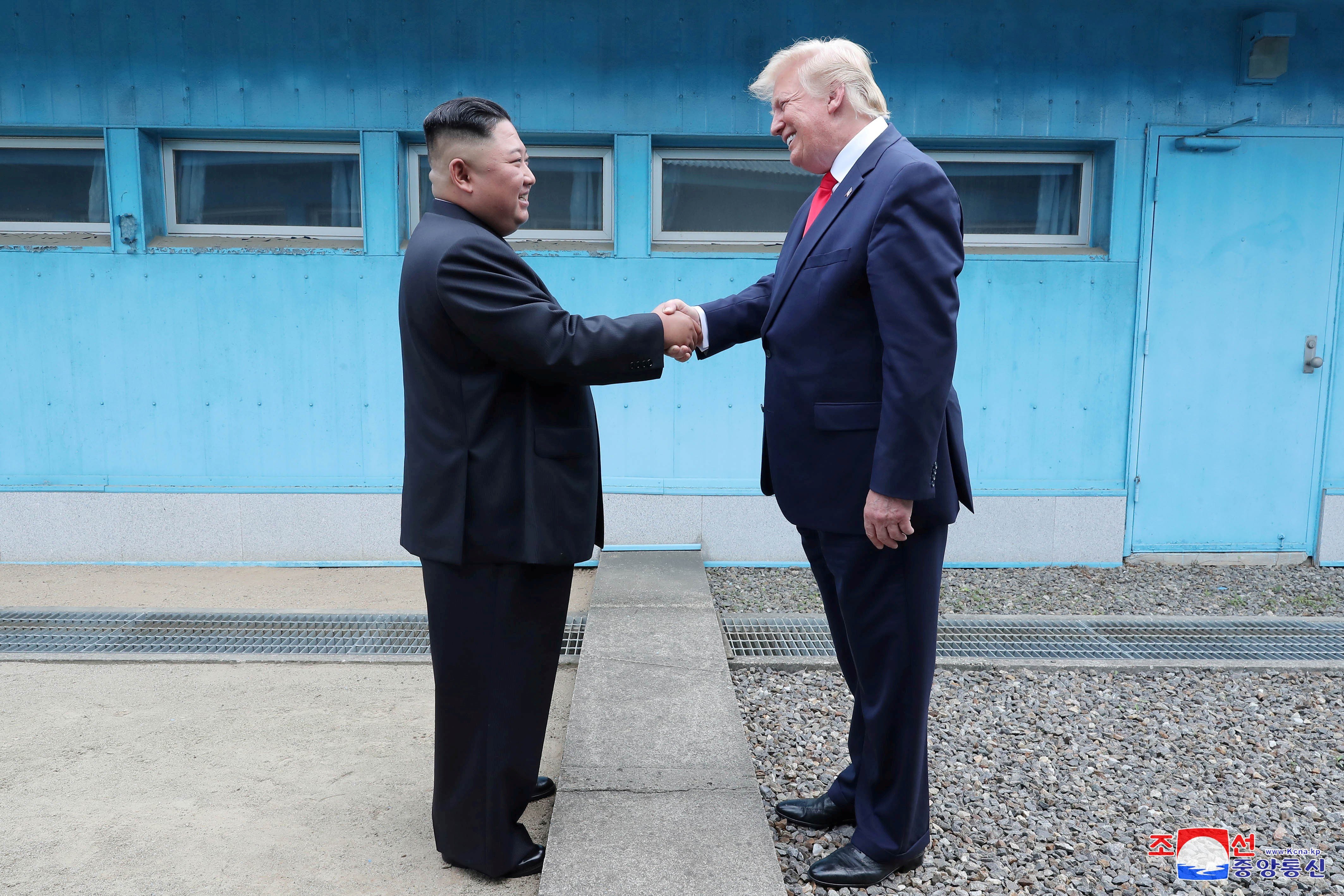 North Korean leader Kim Jong-un shakes hands with US President Donald Trump as they meet at the demilitarised zone separating the two Koreas on June 30. Photo: KCNA via Reuters