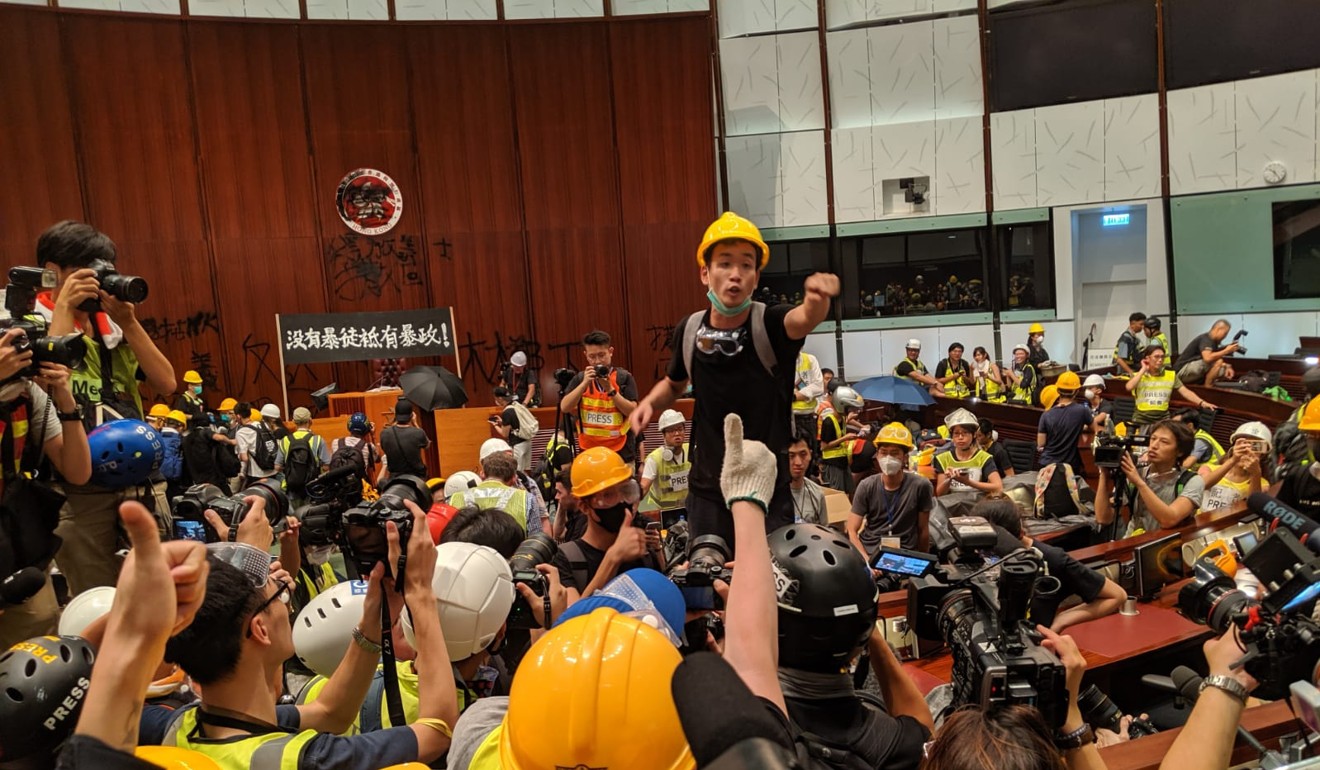 Unmasked protester Brian Leung speaks to protesters after they stormed into the Legislative Council on July 1. Photo: Sum Lok-kei