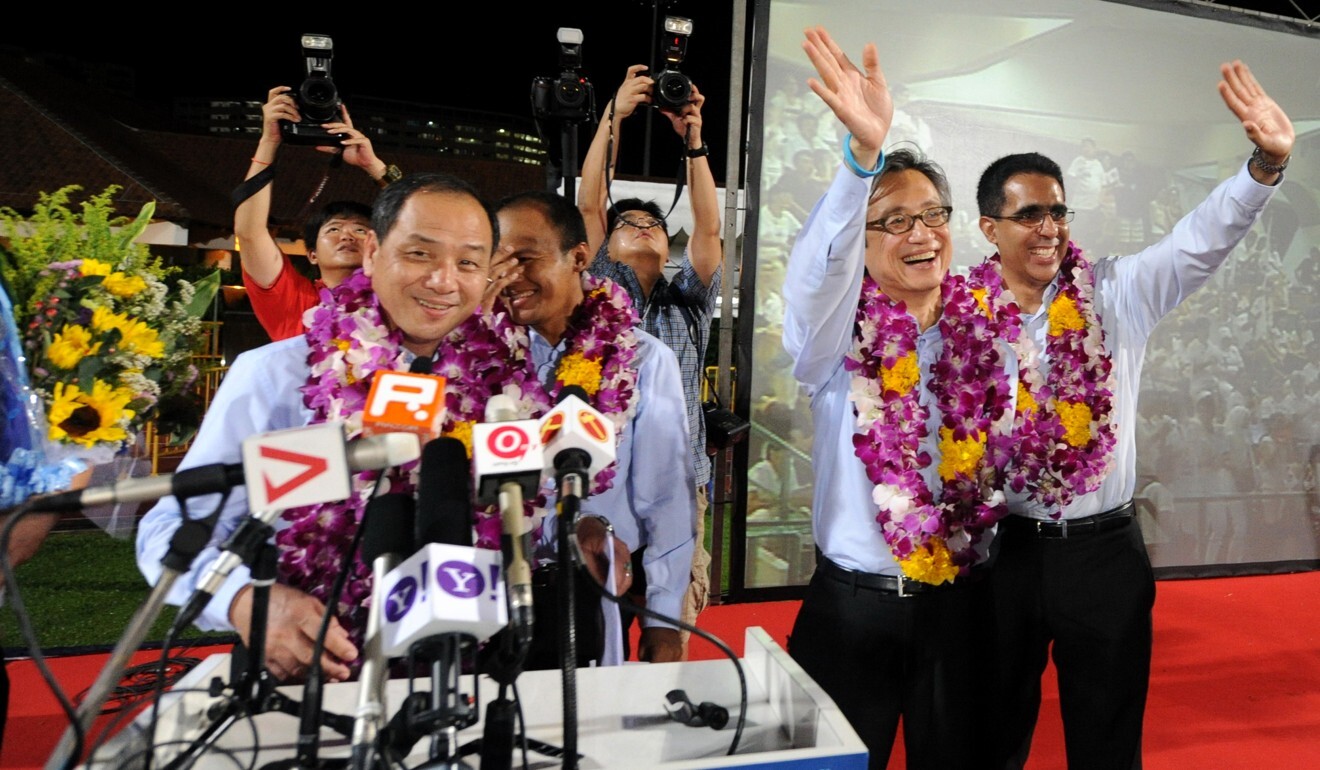 Low Thia Khiang of the opposition Workers’ Party (left) smiles after his party won five Parliament seats in the 2011 general election. Photo: AFP