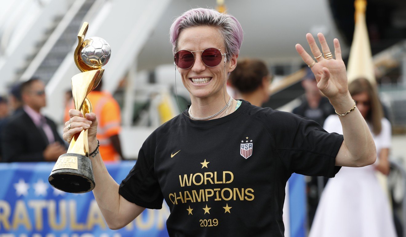 United States women’s soccer team member Megan Rapinoe holds the Women’s World Cup trophy as she celebrates after arriving in New Jersey, USA, on Monday. Photo: AP
