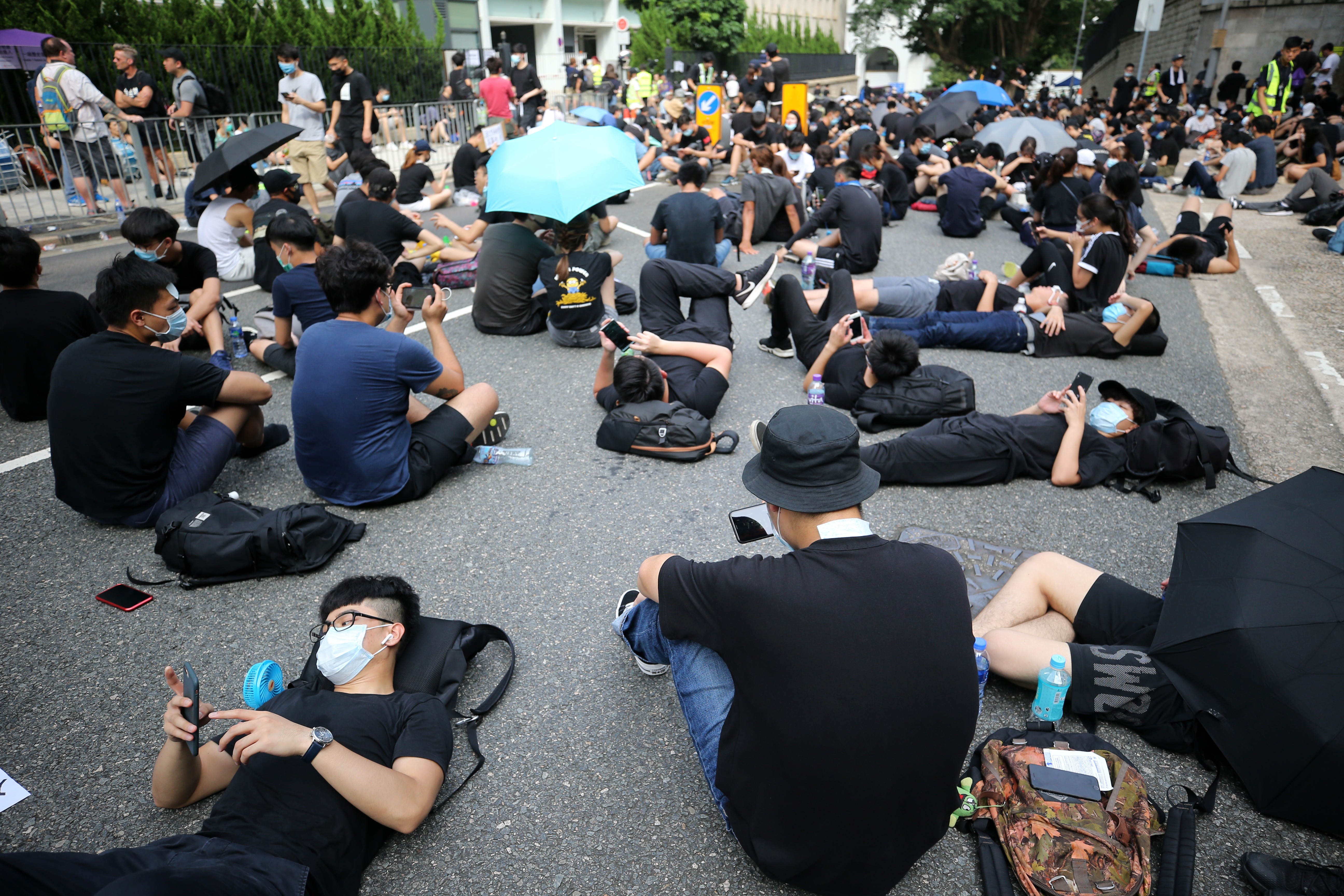 Extradition bill demonstrators take a break outside the Department of Justice in Hong Kong last month. The use of encrypted messaging, peer-to-peer communication technology, doxing and cyber attacks have shown that the protest is also very much in the digital realm. Photo: Sam Tsang