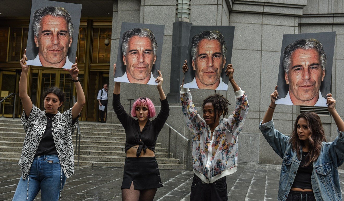 Young protesters hold pictures of Jeffrey Epstein outside the Federal Court in downtown Manhattan. Photo: AFP