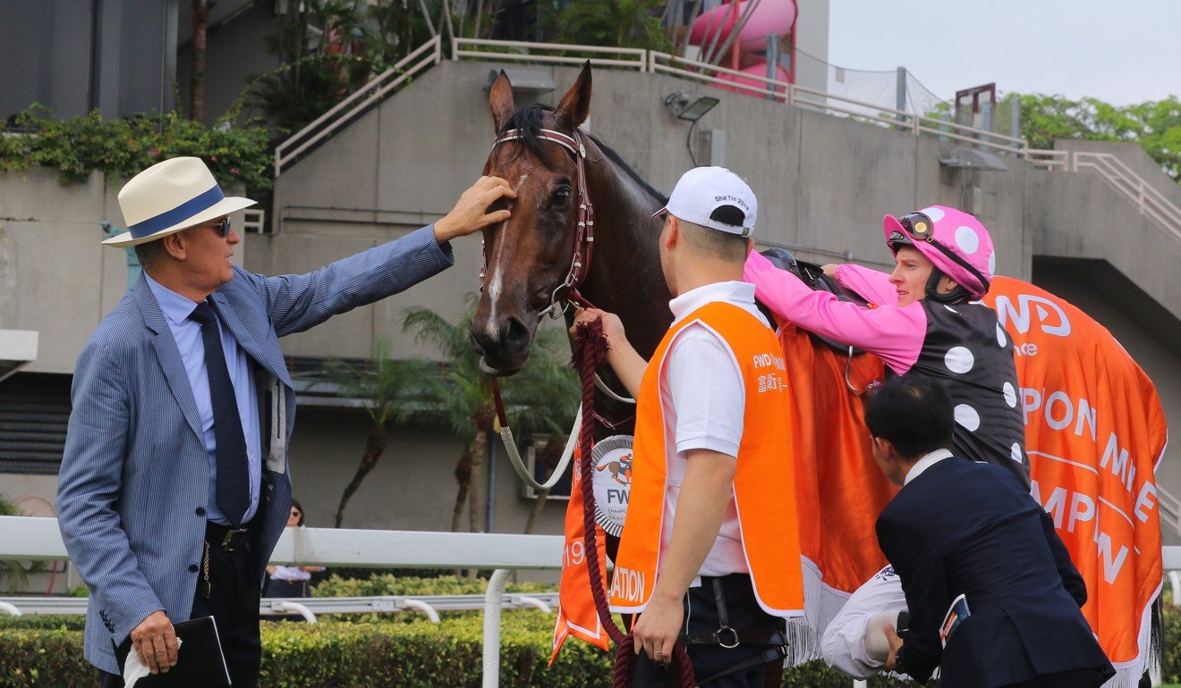 John Moore pats Beauty Generation after his second consecutive Group One Champions Mile this season.