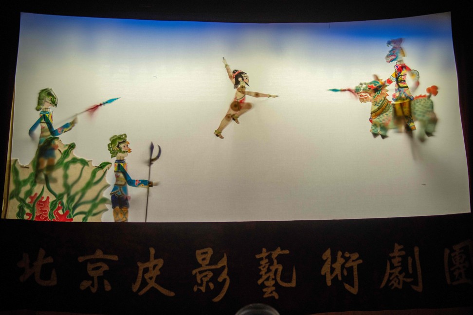 Puppets are seen on a shadow theatre stage during a performance by the Beijing Shadow Show Troupe at a school in Beijing. Photo: AFP