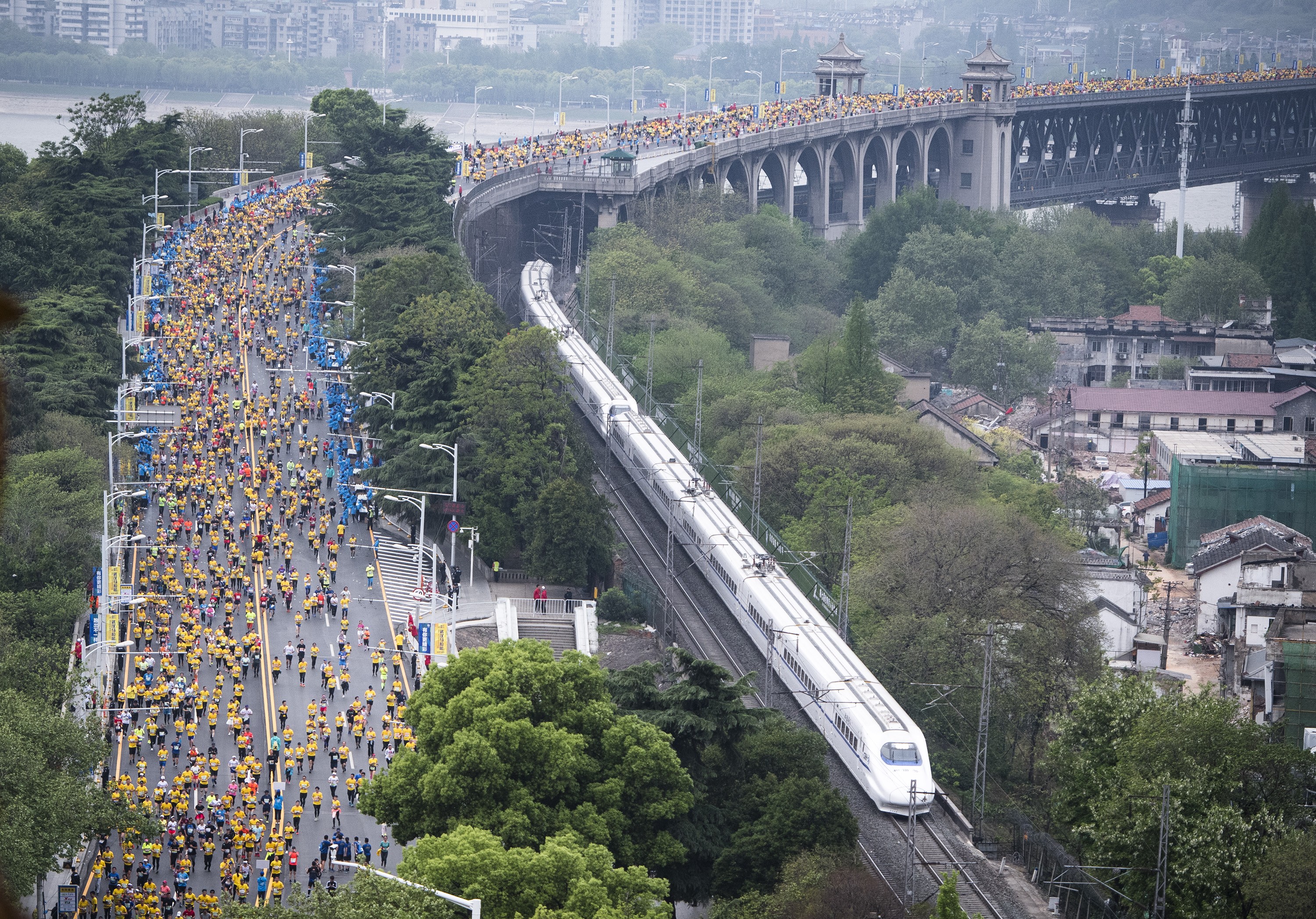 Runners cross the Wuhan Yangtze River Bridge during the 2019 Wuhan Marathon in Hubei province, China. About 24,000 participants took part. Photo: Xinhua