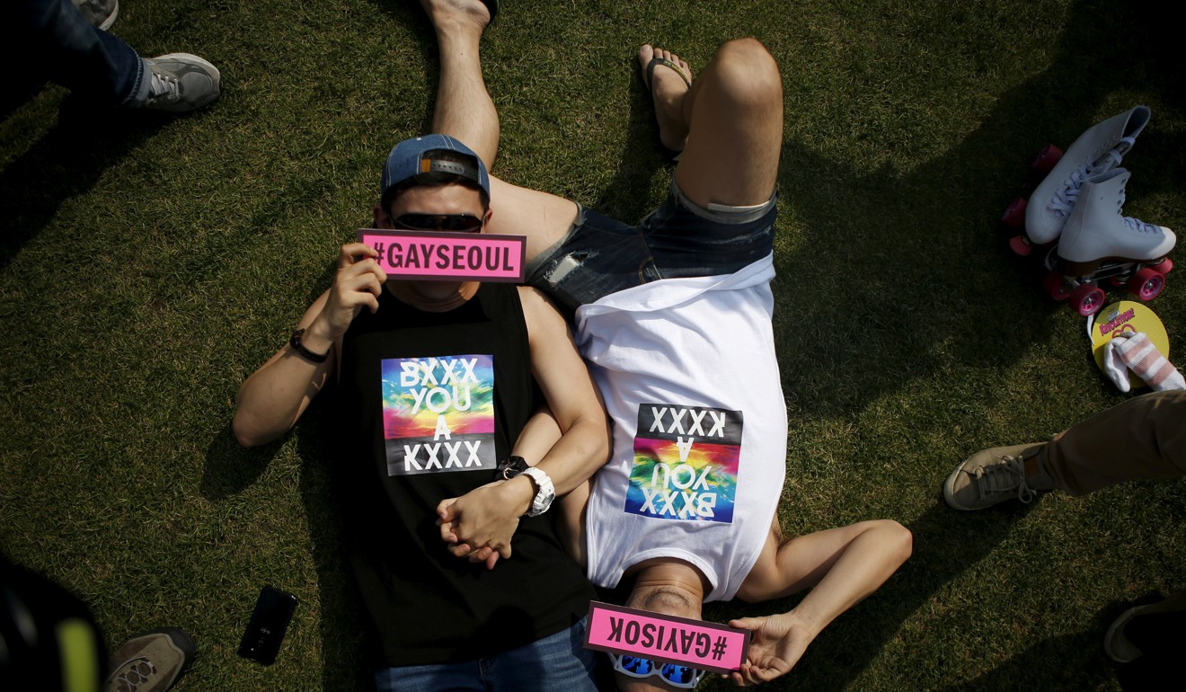 A gay couple lies on a lawn during Korea Queer Festival in Seoul. Photo: Reuters